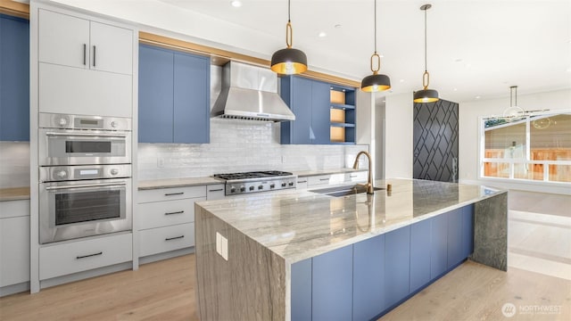 17109 NE 16th Pl, Bellevue, WA 98008 - kitchen featuring a sink, wall chimney exhaust hood, stainless steel appliances, light wood-style flooring, and backsplash