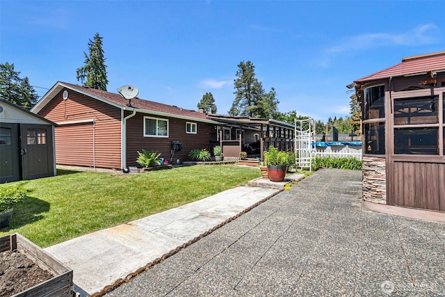 17009 15th Ave E, Spanaway, WA 98387 - rear view of property with a lawn, a patio, and a sunroom