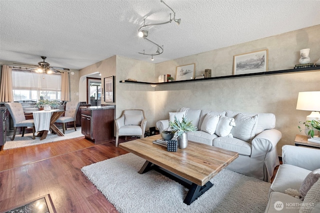 17009 15th Ave E, Spanaway, WA 98387 - living area with wood finished floors, a ceiling fan, and a textured ceiling