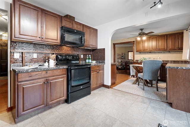 17009 15th Ave E, Spanaway, WA 98387 - kitchen featuring black appliances, backsplash, ceiling fan, arched walkways, and brown cabinetry