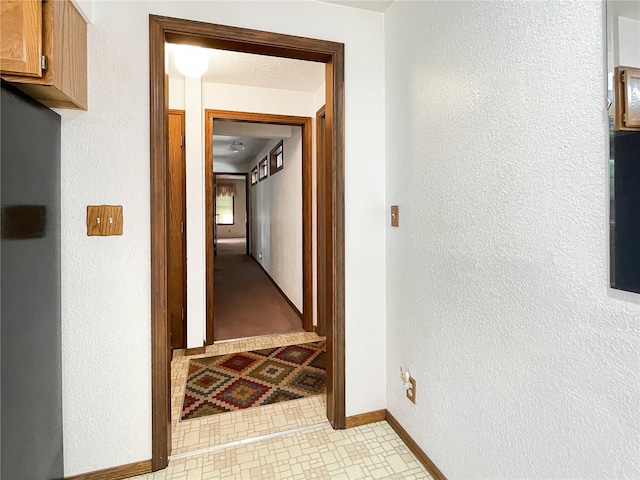 2147 Beverly Blvd, Shelton, WA 98584 - hallway with baseboards, a textured wall, and light tile patterned floors