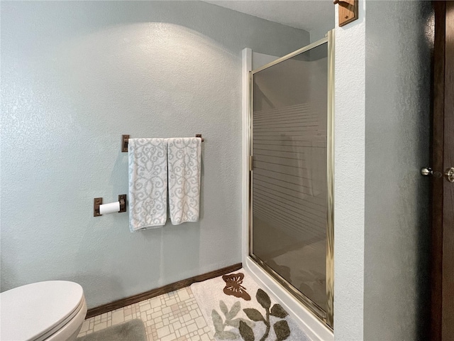 2147 Beverly Blvd, Shelton, WA 98584 - bathroom featuring a shower stall, toilet, baseboards, and tile patterned flooring