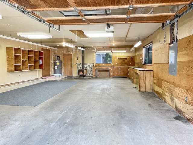 2147 Beverly Blvd, Shelton, WA 98584 - garage featuring water heater, electric panel, a garage door opener, and a wood stove