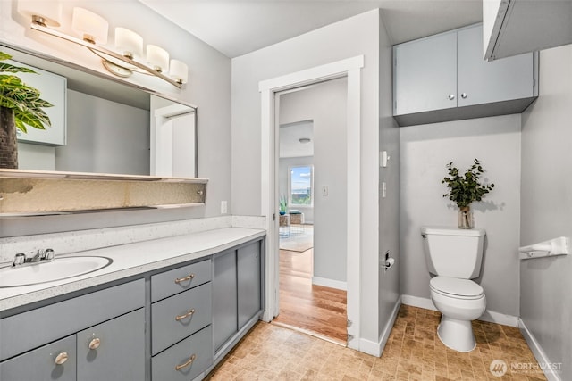 2042 E Harrison St, Tacoma, WA 98404 - bathroom featuring toilet, baseboards, and vanity