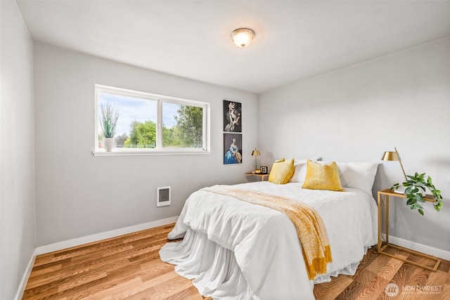 2042 E Harrison St, Tacoma, WA 98404 - bedroom featuring baseboards, wood finished floors, and heating unit