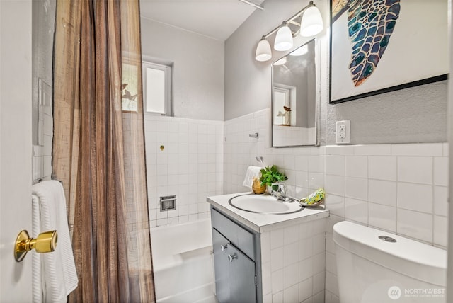 2042 E Harrison St, Tacoma, WA 98404 - full bathroom with toilet, vanity, tile walls, and shower / bath combination with curtain