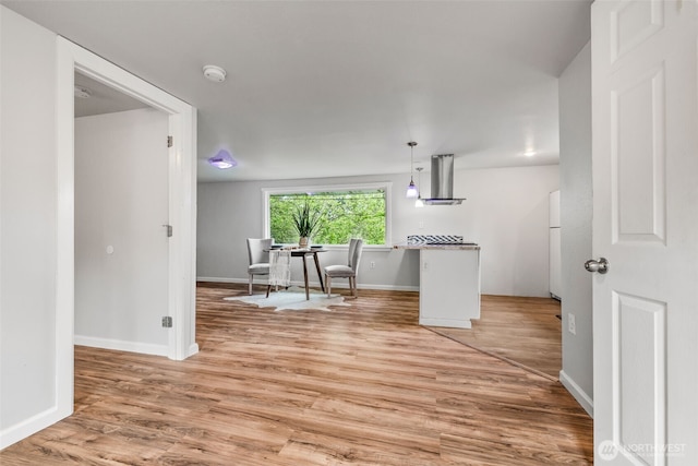 2042 E Harrison St, Tacoma, WA 98404 - kitchen with range hood, light wood-style floors, baseboards, and hanging light fixtures