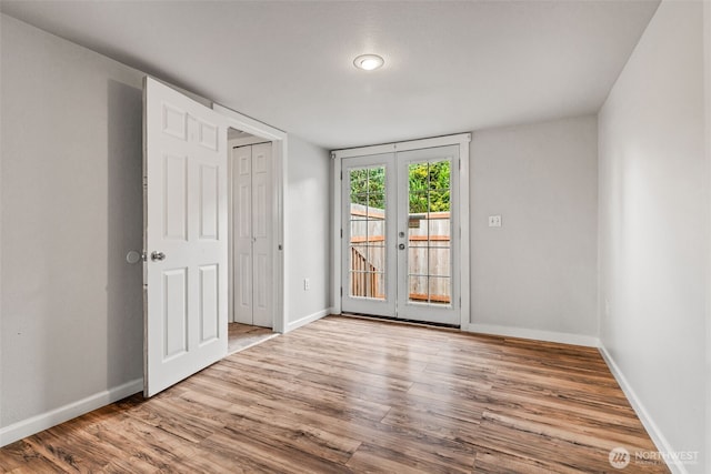 2042 E Harrison St, Tacoma, WA 98404 - unfurnished bedroom with french doors, access to exterior, wood finished floors, and baseboards