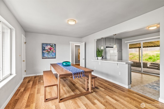 2042 E Harrison St, Tacoma, WA 98404 - dining space with light wood-type flooring and baseboards