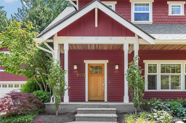 9385 NE N Town Loop, Bainbridge Island, WA 98110 - doorway to property with a porch, a shingled roof, board and batten siding, and a garage