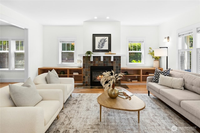 9385 NE N Town Loop, Bainbridge Island, WA 98110 - living room featuring a fireplace, wood finished floors, and recessed lighting