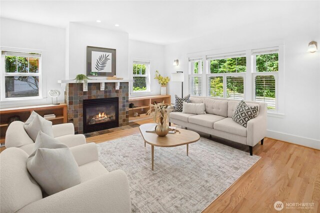 9385 NE N Town Loop, Bainbridge Island, WA 98110 - living area with wood finished floors, baseboards, a fireplace, and recessed lighting