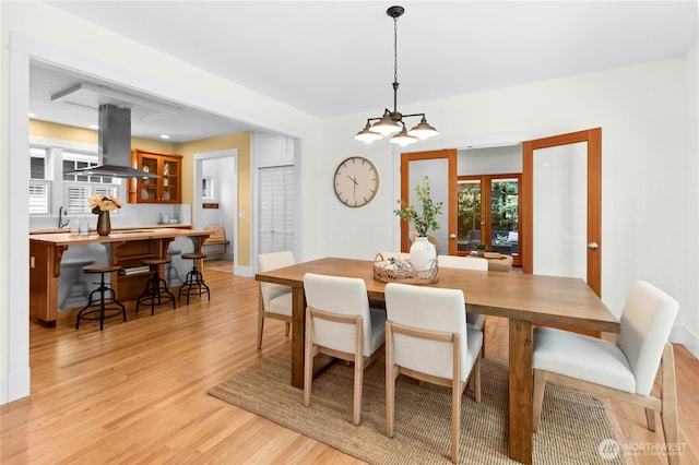 9385 NE N Town Loop, Bainbridge Island, WA 98110 - dining room with light wood-style flooring, french doors, and baseboards