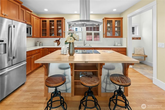 9385 NE N Town Loop, Bainbridge Island, WA 98110 - kitchen featuring appliances with stainless steel finishes, wooden counters, a kitchen bar, and recessed lighting