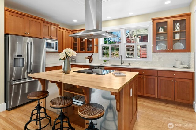 9385 NE N Town Loop, Bainbridge Island, WA 98110 - kitchen featuring stainless steel appliances, a sink, island exhaust hood, butcher block countertops, and recessed lighting
