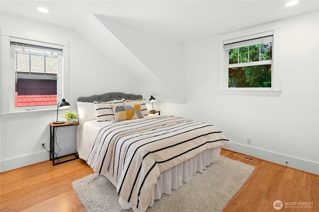 9385 NE N Town Loop, Bainbridge Island, WA 98110 - bedroom with multiple windows, recessed lighting, baseboards, and wood finished floors