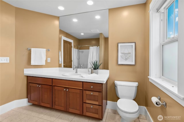 9385 NE N Town Loop, Bainbridge Island, WA 98110 - bathroom featuring toilet, vanity, baseboards, tile patterned flooring, and recessed lighting