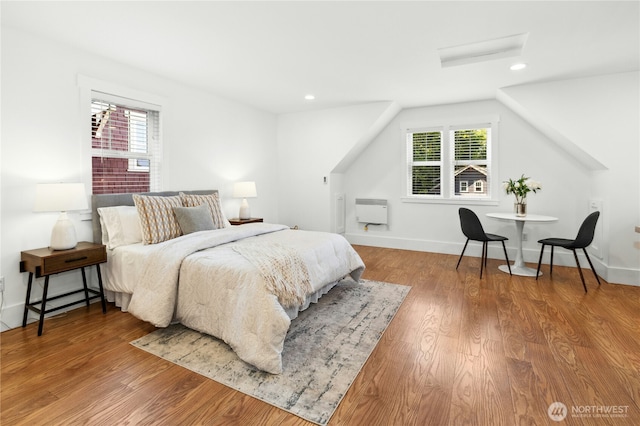 9385 NE N Town Loop, Bainbridge Island, WA 98110 - bedroom with multiple windows, wood finished floors, heating unit, recessed lighting, and baseboards