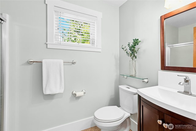 9385 NE N Town Loop, Bainbridge Island, WA 98110 - bathroom with toilet, vanity, a shower with door, and baseboards