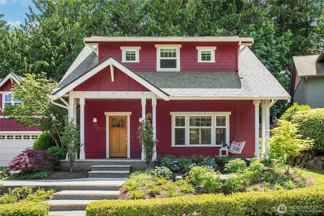 9385 NE N Town Loop, Bainbridge Island, WA 98110 - view of front facade featuring a shingled roof, board and batten siding, a porch, and an attached garage