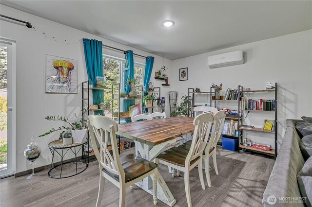 13218 197th St E, Graham, WA 98338 - dining space with a wall mounted AC and wood finished floors