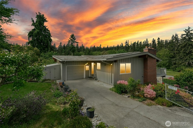 1240 Beach Dr, Camano Island, WA 98282 - view of front of house with a garage, a chimney, and asphalt driveway