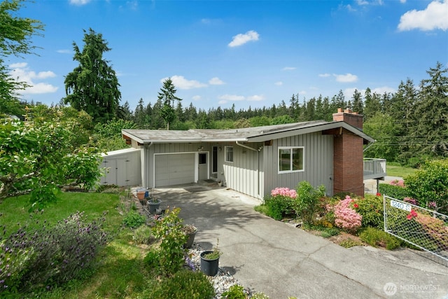 1240 Beach Dr, Camano Island, WA 98282 - view of front facade with a garage, a chimney, and asphalt driveway