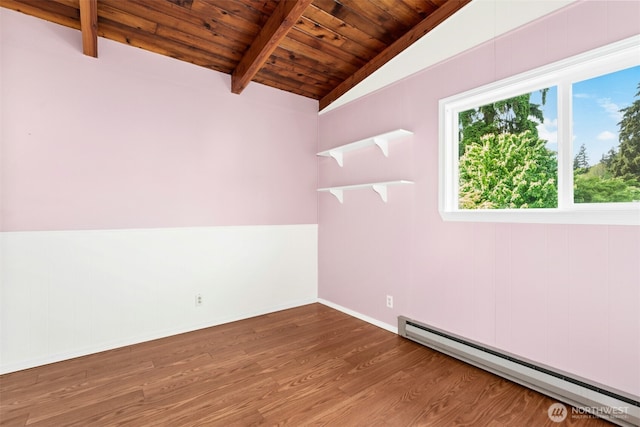 1240 Beach Dr, Camano Island, WA 98282 - empty room with a baseboard heating unit, wooden ceiling, wood finished floors, and baseboards