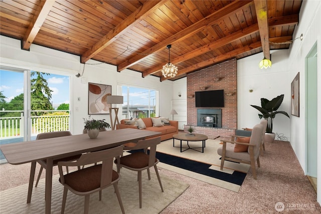1240 Beach Dr, Camano Island, WA 98282 - carpeted dining space featuring wood ceiling, a chandelier, and a fireplace