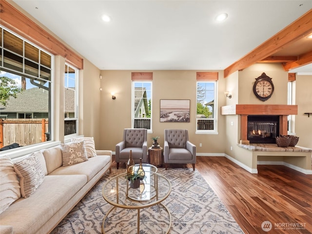 20409 70th St E, Bonney Lake, WA 98391 - living room featuring a glass covered fireplace, recessed lighting, wood finished floors, baseboards, and beamed ceiling