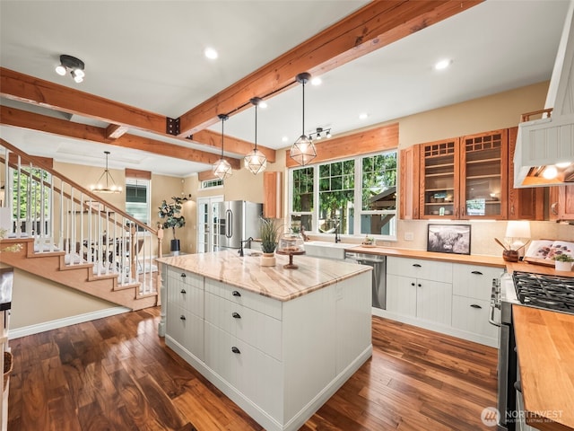 20409 70th St E, Bonney Lake, WA 98391 - kitchen featuring wood counters, stainless steel appliances, beam ceiling, dark wood-type flooring, and an island with sink