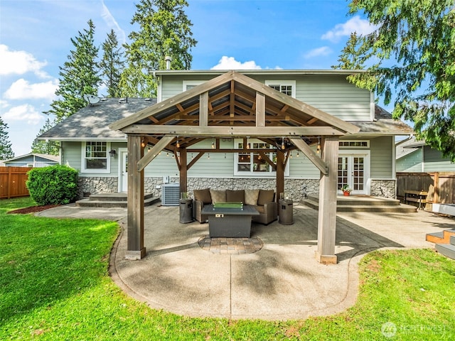 20409 70th St E, Bonney Lake, WA 98391 - rear view of property featuring an outdoor hangout area, a gazebo, a patio, stone siding, and central AC unit