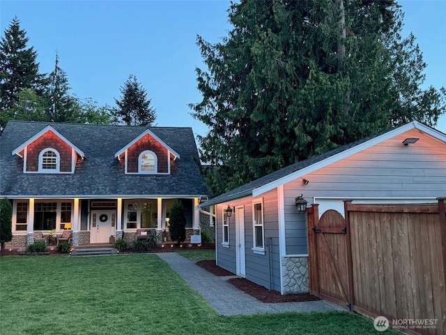 20409 70th St E, Bonney Lake, WA 98391 - view of front of home featuring covered porch, a front yard, roof with shingles, a gate, and stone siding