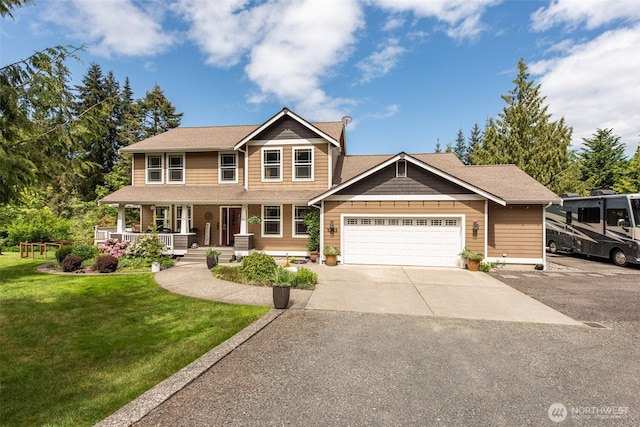 1063 Tamarack Ln, Port Angeles, WA 98362 - view of front of home featuring a porch, a front lawn, concrete driveway, and an attached garage