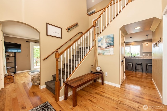 1063 Tamarack Ln, Port Angeles, WA 98362 - stairway with wood finished floors, arched walkways, plenty of natural light, baseboards, and recessed lighting