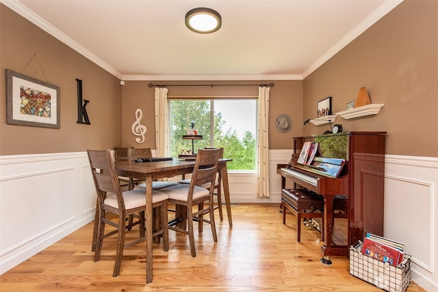 1063 Tamarack Ln, Port Angeles, WA 98362 - dining room featuring a decorative wall, light wood finished floors, a wainscoted wall, and ornamental molding