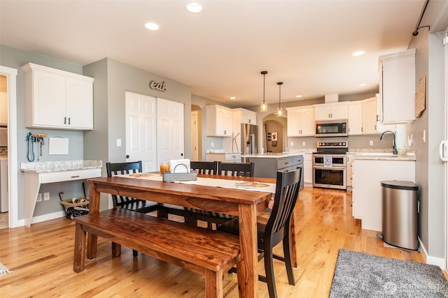 1063 Tamarack Ln, Port Angeles, WA 98362 - dining room with light wood-style floors, recessed lighting, arched walkways, and baseboards