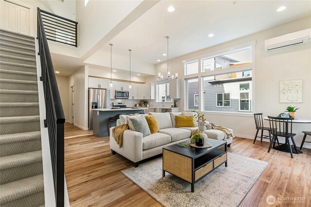 4246 Cameo Ln, Bellingham, WA 98226 - living area featuring a wall unit AC, a chandelier, stairway, light wood-type flooring, and recessed lighting