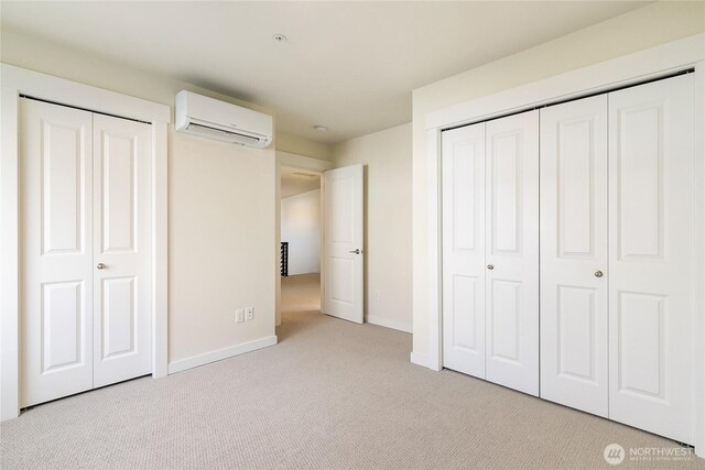 4246 Cameo Ln, Bellingham, WA 98226 - unfurnished bedroom with a wall mounted AC, carpet, and baseboards