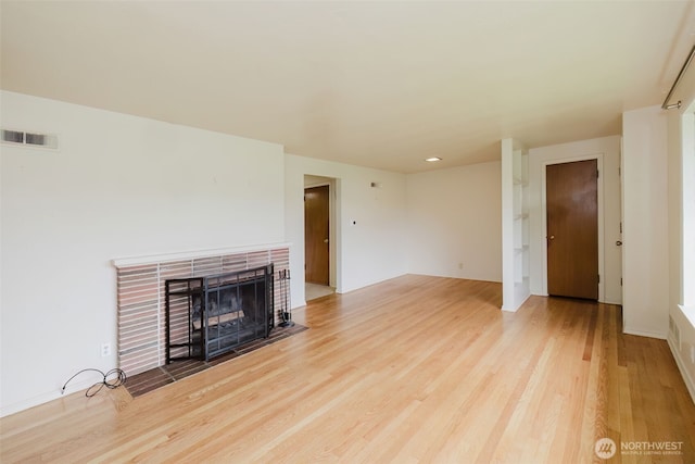 2409 Veldee Ave, Bremerton, WA 98312 - unfurnished living room featuring a fireplace with flush hearth, wood finished floors, and baseboards