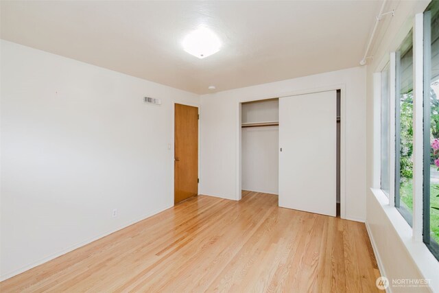 2409 Veldee Ave, Bremerton, WA 98312 - unfurnished bedroom with light wood finished floors, multiple windows, and a closet