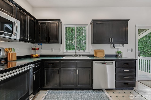 12721 56th Dr NE, Marysville, WA 98271 - kitchen with stainless steel appliances, a sink, and dark countertops