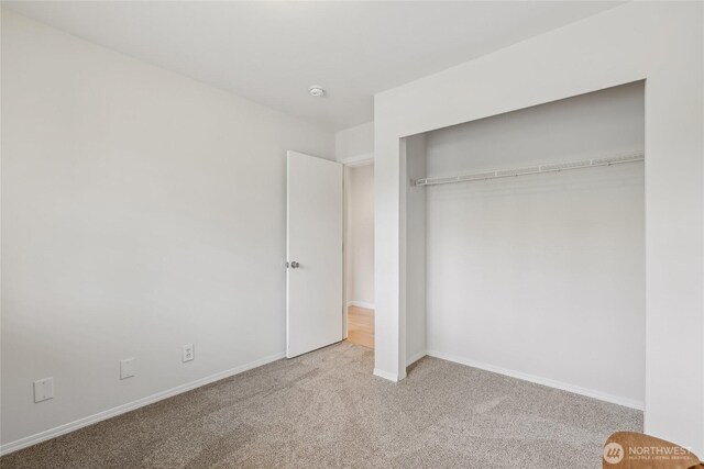 12721 56th Dr NE, Marysville, WA 98271 - unfurnished bedroom with carpet floors, a closet, and baseboards