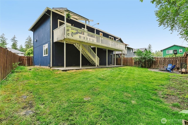 12721 56th Dr NE, Marysville, WA 98271 - back of property featuring a wooden deck, stairs, and a patio area
