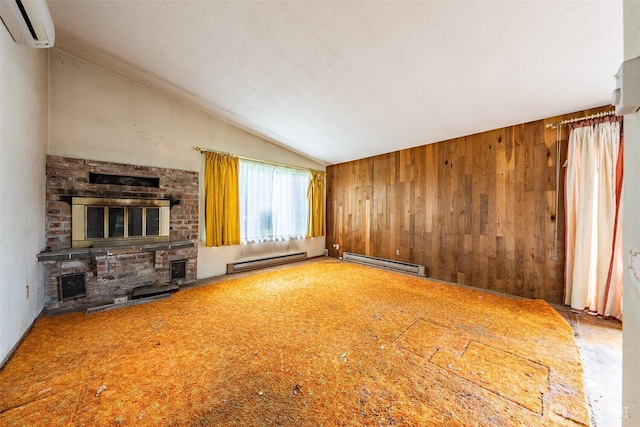 1216 E 70th St, Tacoma, WA 98404 - unfurnished living room with a baseboard heating unit, a wall unit AC, lofted ceiling, wood walls, and a fireplace