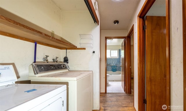 1216 E 70th St, Tacoma, WA 98404 - laundry room featuring washing machine and clothes dryer and wood finished floors