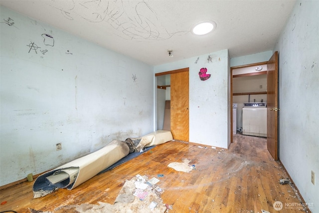 1216 E 70th St, Tacoma, WA 98404 - unfurnished bedroom featuring hardwood / wood-style floors and washing machine and clothes dryer