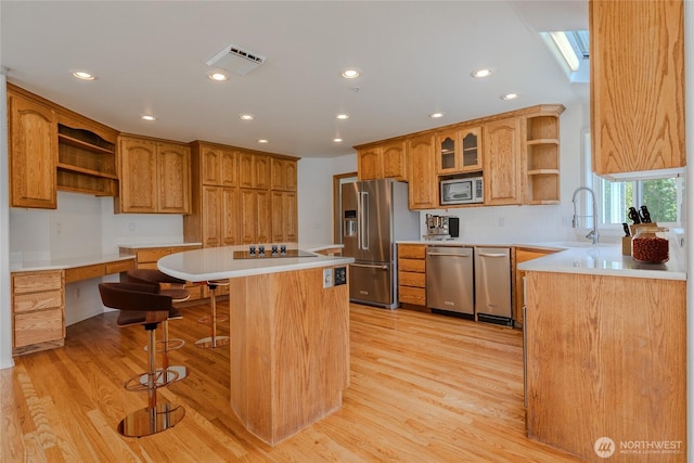 5501 55th St SE, Auburn, WA 98092 - kitchen featuring open shelves, stainless steel appliances, a kitchen island, a breakfast bar, and recessed lighting