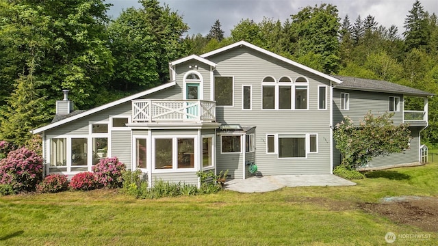 5501 55th St SE, Auburn, WA 98092 - rear view of property with a balcony, a patio, a chimney, and a yard