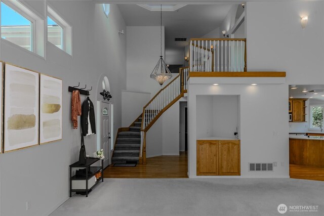 5501 55th St SE, Auburn, WA 98092 - staircase with a high ceiling, carpet flooring, and baseboards